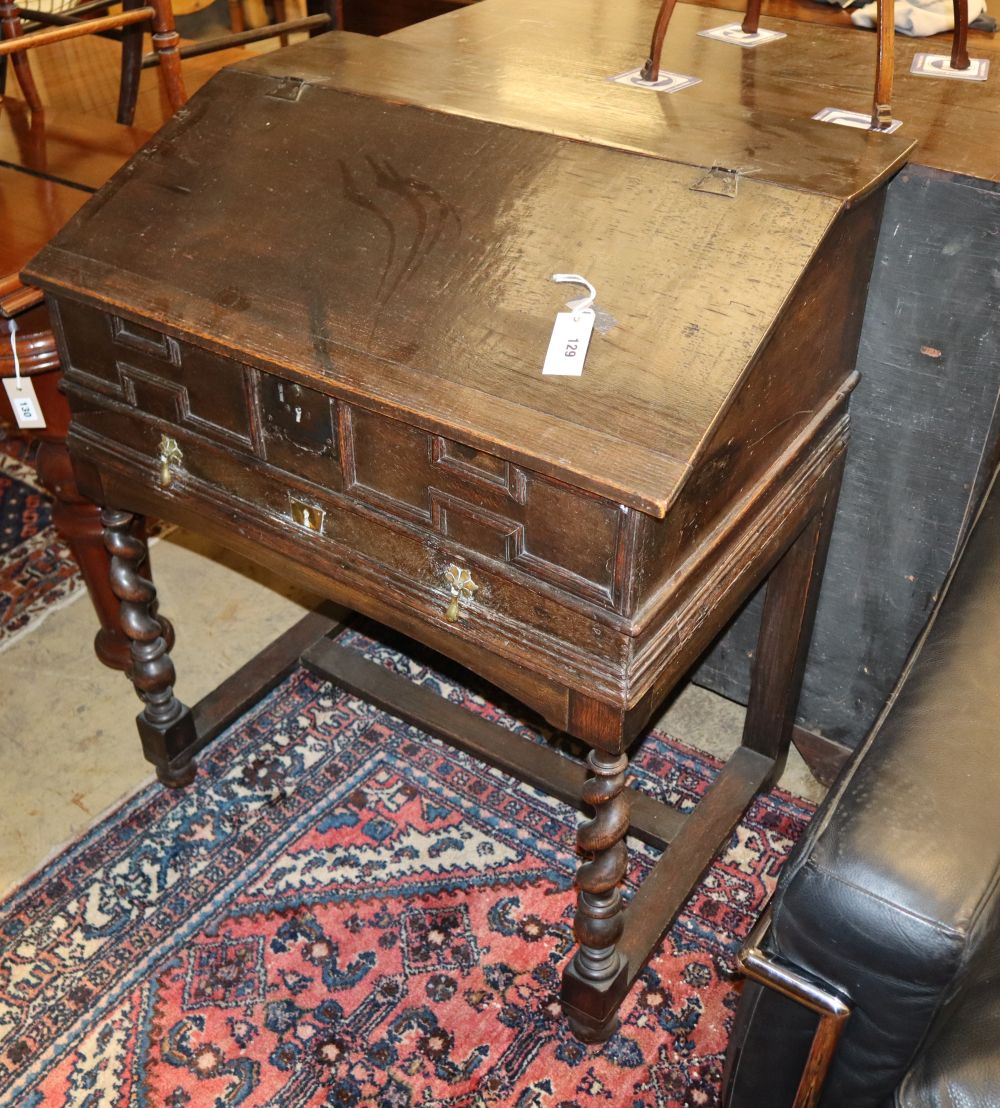 An antique oak desk with hinged slope and geometric moulding, W.80cm, D.56cm, H.97cm